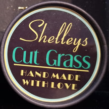 Load image into Gallery viewer, the view of the top of our cut grass wax melt jars with the lid on
